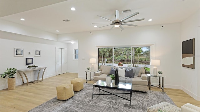 living room with ceiling fan and light wood-type flooring