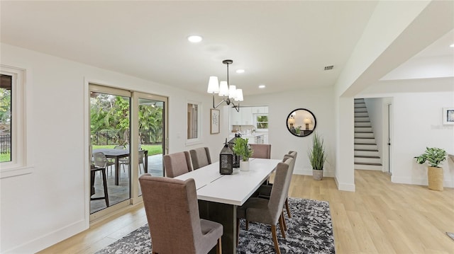 dining space featuring a chandelier and light hardwood / wood-style flooring