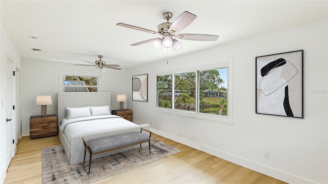 bedroom with ceiling fan and light hardwood / wood-style flooring