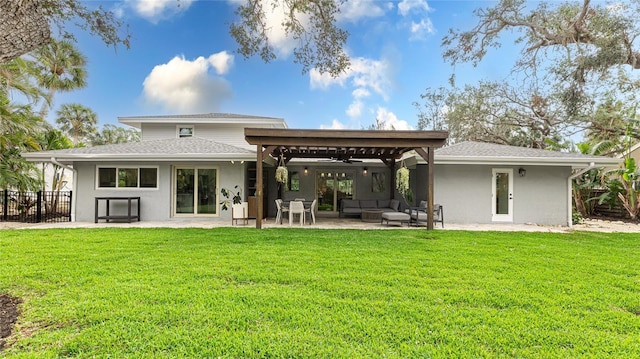 back of house with a patio, outdoor lounge area, a yard, and ceiling fan