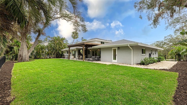 back of house featuring a patio and a lawn