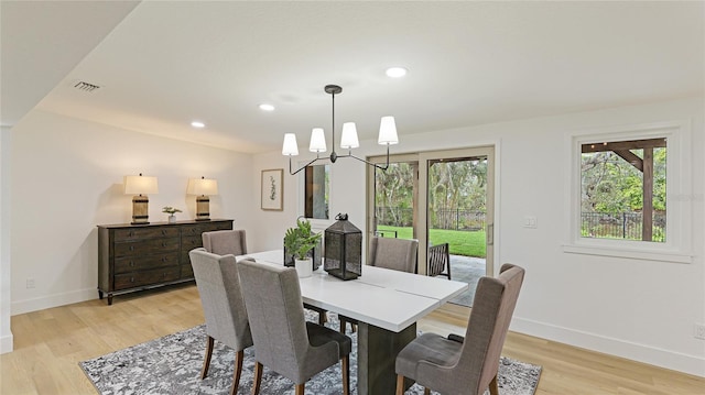 dining space with light wood-type flooring, baseboards, a notable chandelier, visible vents, and recessed lighting