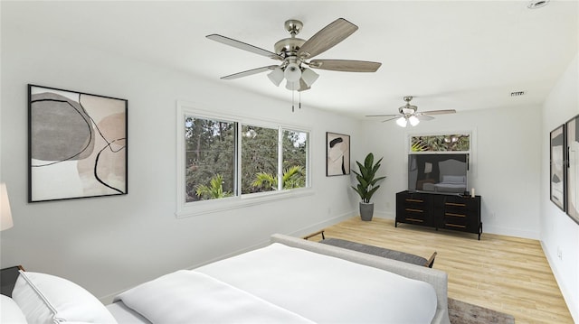 bedroom with baseboards, a ceiling fan, and wood finished floors