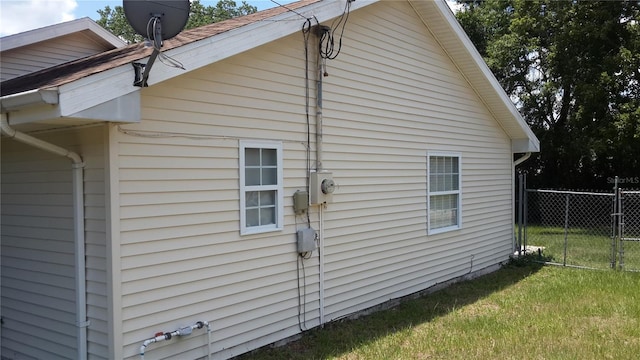 view of side of home featuring a lawn