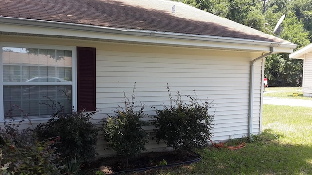 view of side of home featuring a yard