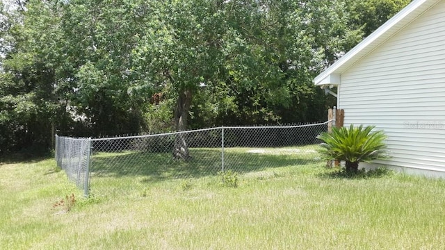 view of property's community with a yard and fence