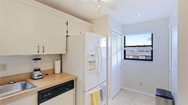 kitchen featuring ceiling fan, light tile patterned floors, white cabinets, and white appliances