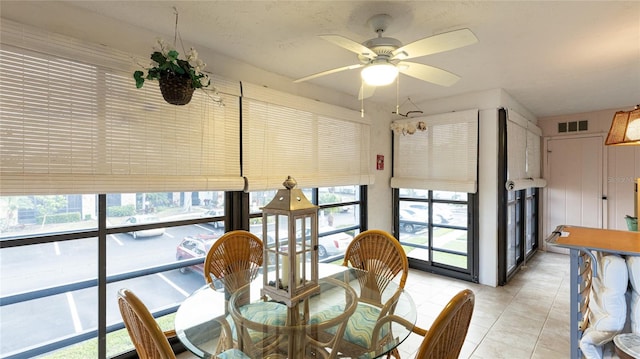 dining space featuring ceiling fan and light tile patterned floors