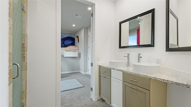 bathroom featuring vanity and an enclosed shower