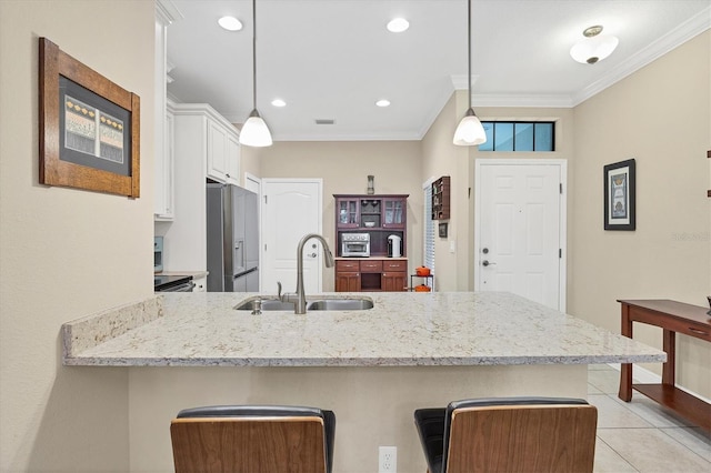 kitchen featuring kitchen peninsula, sink, decorative light fixtures, white cabinets, and stainless steel fridge with ice dispenser