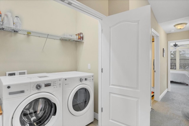 laundry room featuring light carpet, ceiling fan, and washer and dryer