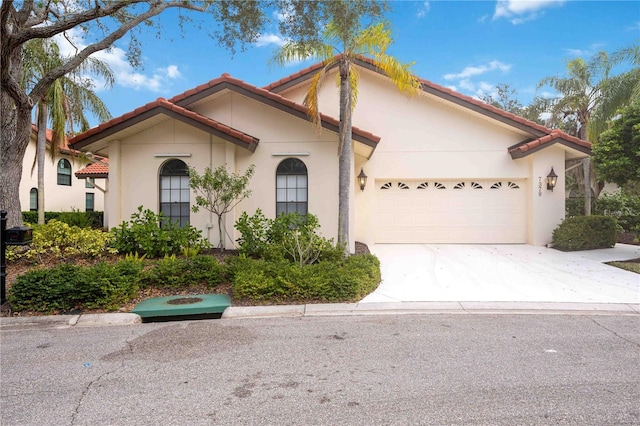 mediterranean / spanish-style home with a garage