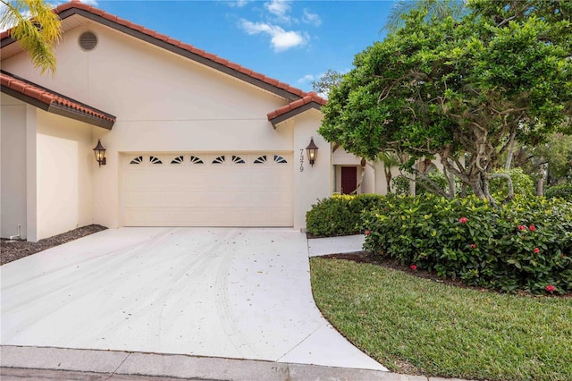 mediterranean / spanish house with a garage