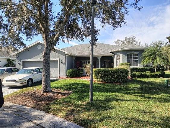 ranch-style house with a front yard and a garage