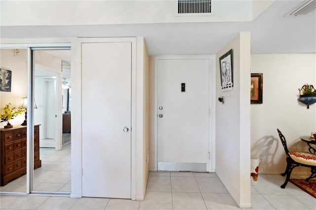 hall featuring light tile patterned floors