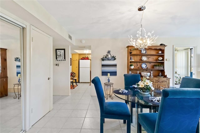 tiled dining space with a notable chandelier