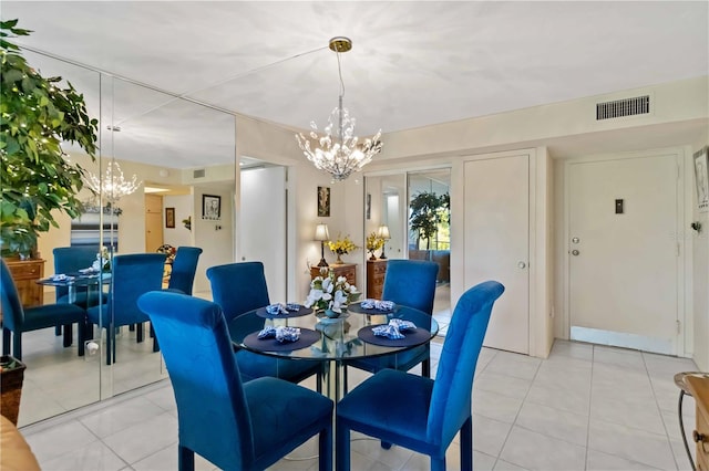 tiled dining space with an inviting chandelier