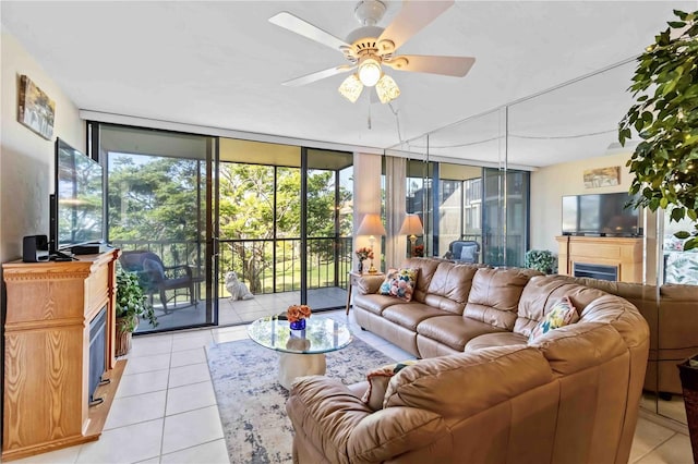 living room with floor to ceiling windows, ceiling fan, and light tile patterned floors