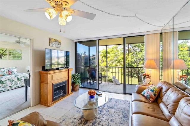 tiled living room featuring floor to ceiling windows and ceiling fan