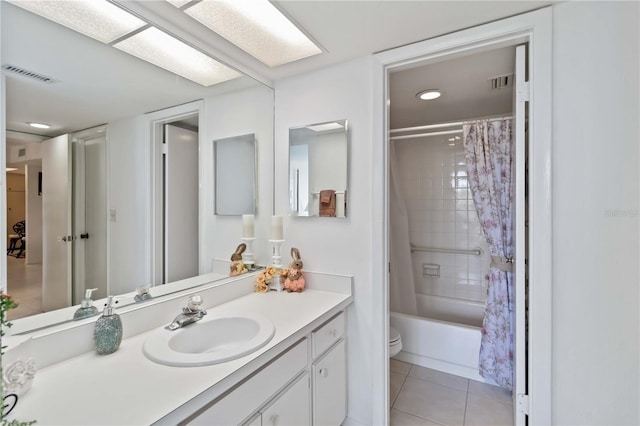 full bathroom featuring tile patterned flooring, vanity, shower / bath combo, and toilet