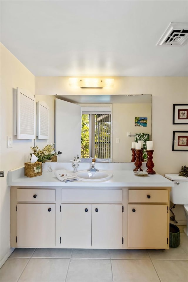 bathroom with tile patterned floors, vanity, and toilet