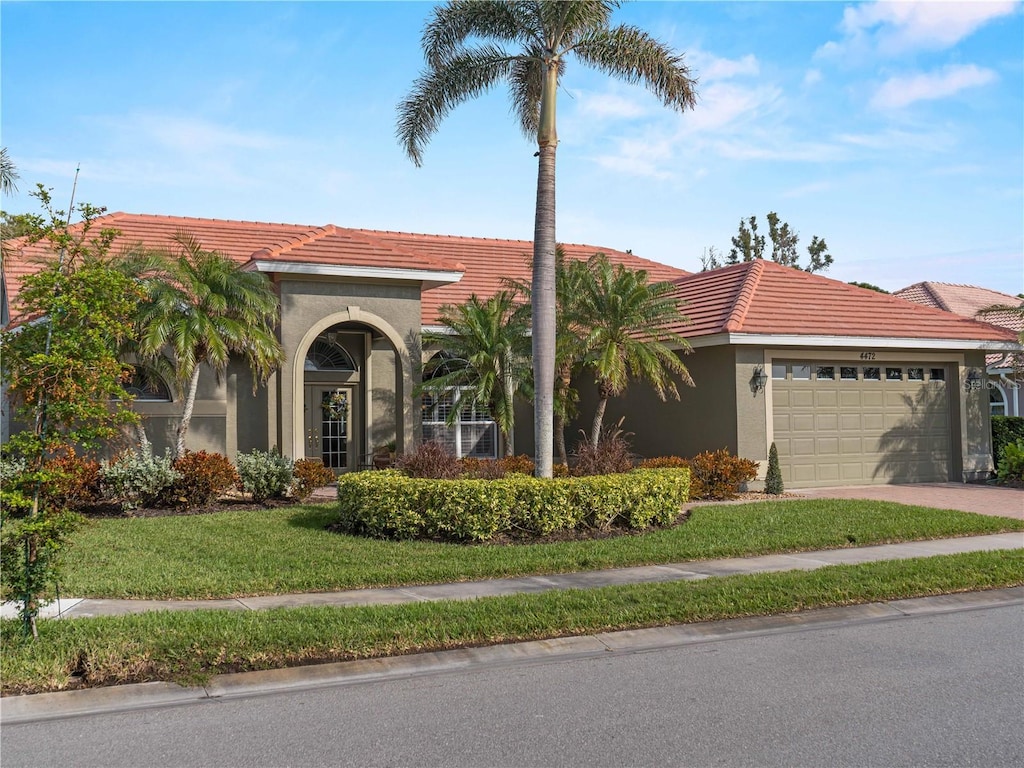 view of front facade with a garage and a front lawn