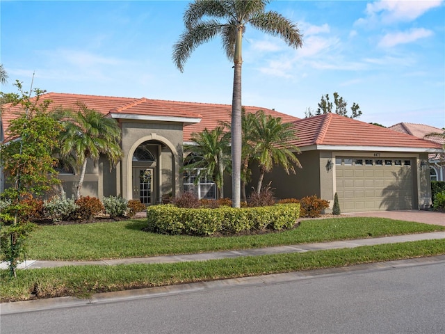 view of front facade with a garage and a front lawn