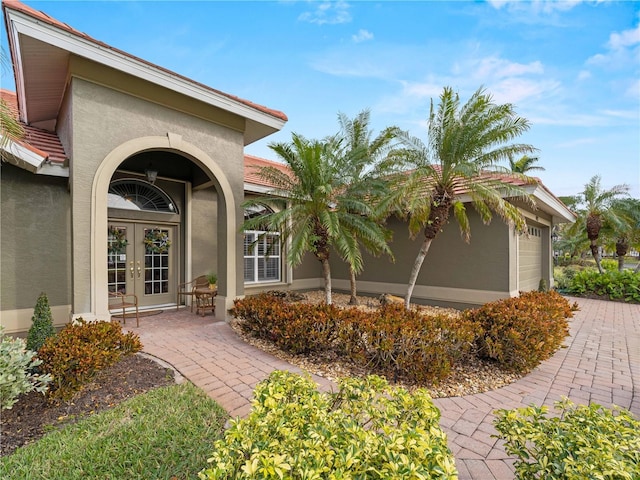 property entrance featuring french doors and a garage