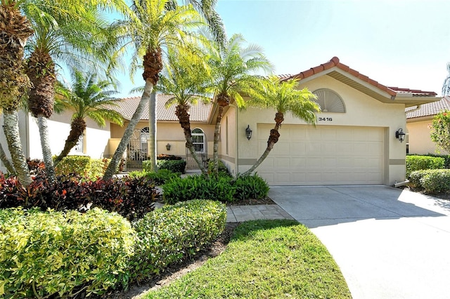 mediterranean / spanish-style home with a garage