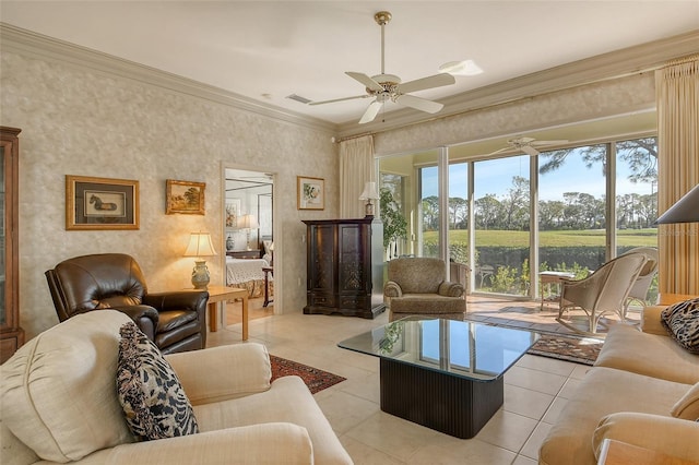 tiled living room with ceiling fan, crown molding, and a water view