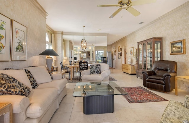 living room with light tile patterned floors, ceiling fan with notable chandelier, and ornamental molding