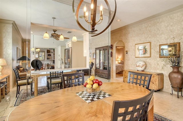 dining space with crown molding and a notable chandelier