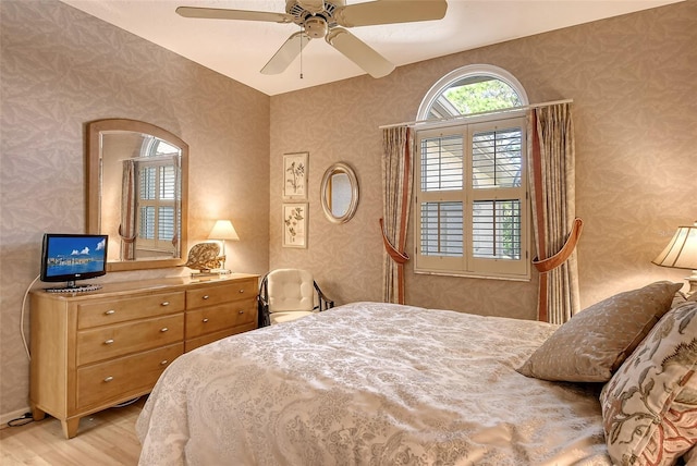 bedroom with ceiling fan and light wood-type flooring