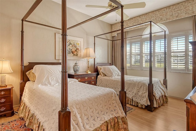 bedroom with ceiling fan and light wood-type flooring