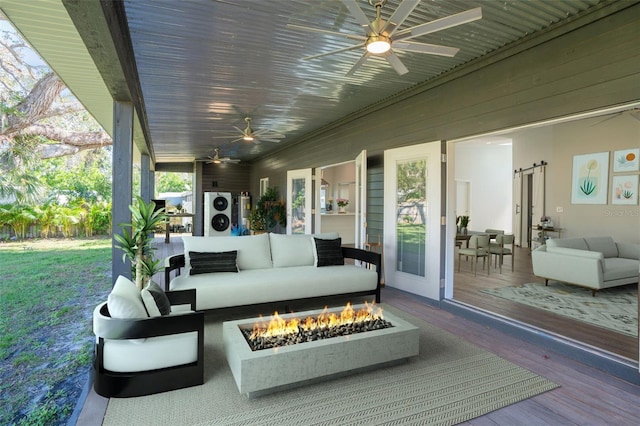 wooden deck featuring an outdoor living space with a fire pit