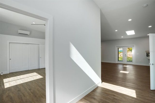 hall with dark hardwood / wood-style floors and a skylight