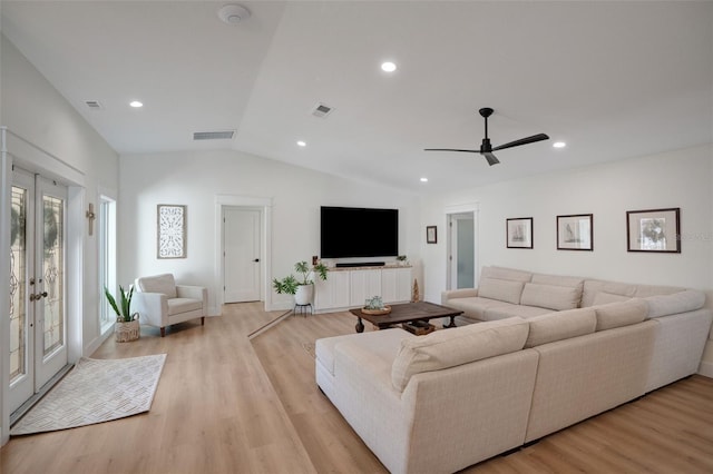 living room featuring vaulted ceiling, french doors, ceiling fan, and light wood-type flooring