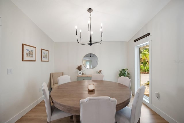 dining area with wood-type flooring and lofted ceiling