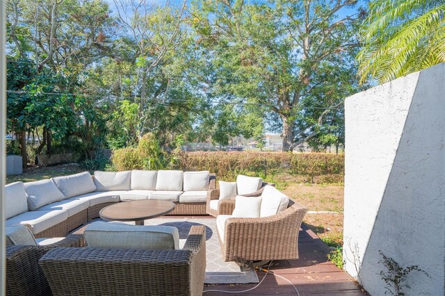 wooden deck with an outdoor living space