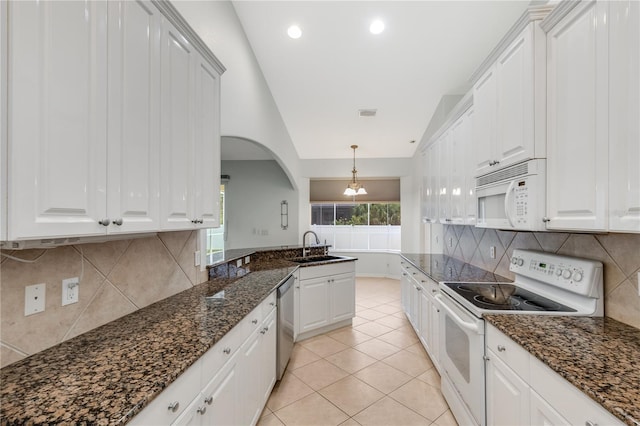 kitchen with white appliances, white cabinets, decorative light fixtures, dark stone countertops, and light tile patterned floors