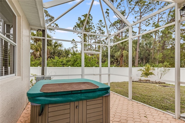 sunroom with a hot tub and a healthy amount of sunlight