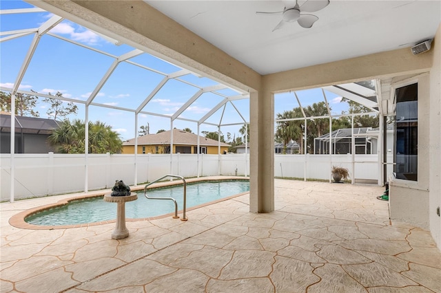 view of pool featuring glass enclosure and a patio