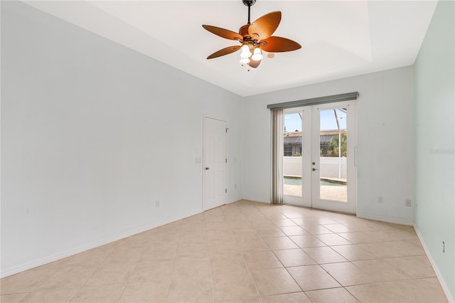 tiled spare room with ceiling fan and french doors