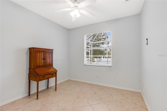 tiled empty room with ceiling fan