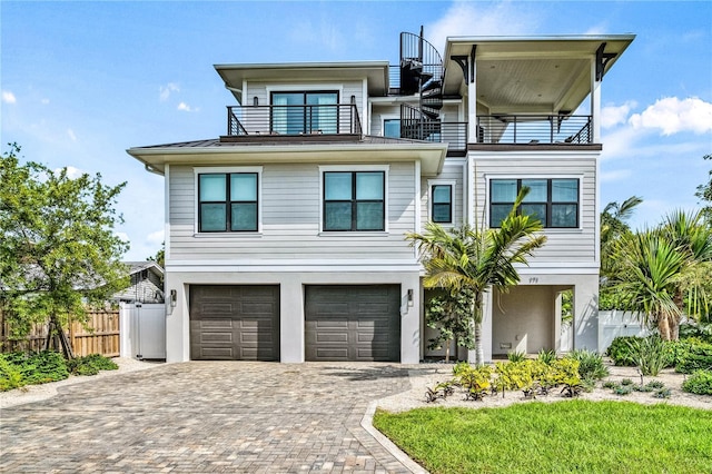 view of front facade featuring a balcony and a garage