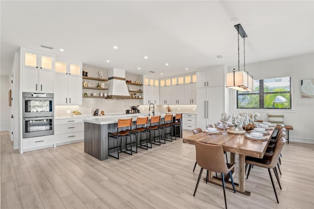 dining space featuring light hardwood / wood-style flooring and sink