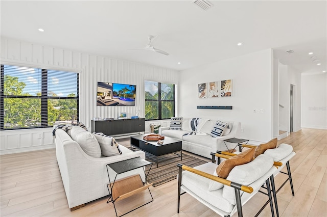 living room with ceiling fan and light hardwood / wood-style floors