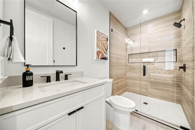 bathroom with tile patterned floors, vanity, toilet, and walk in shower