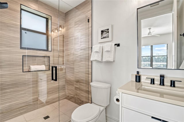 bathroom with ceiling fan, a shower with door, vanity, and toilet