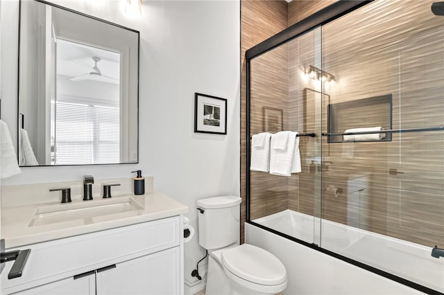 full bathroom featuring vanity, toilet, ceiling fan, and enclosed tub / shower combo